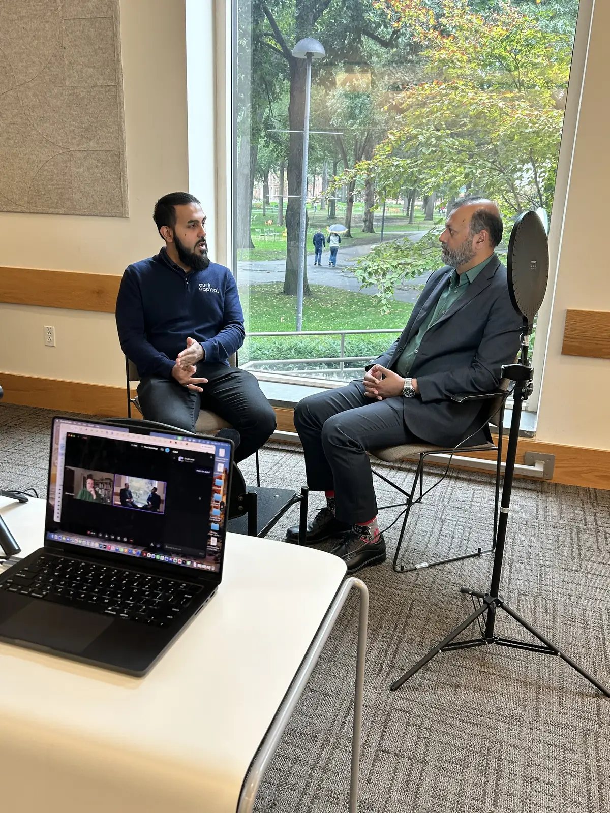 Two people in conversation during a Kufi recording
