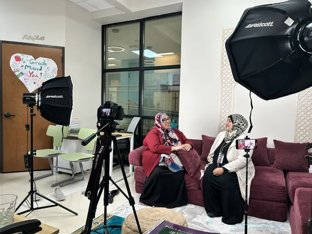 Two women interviewed on camera under studio lights